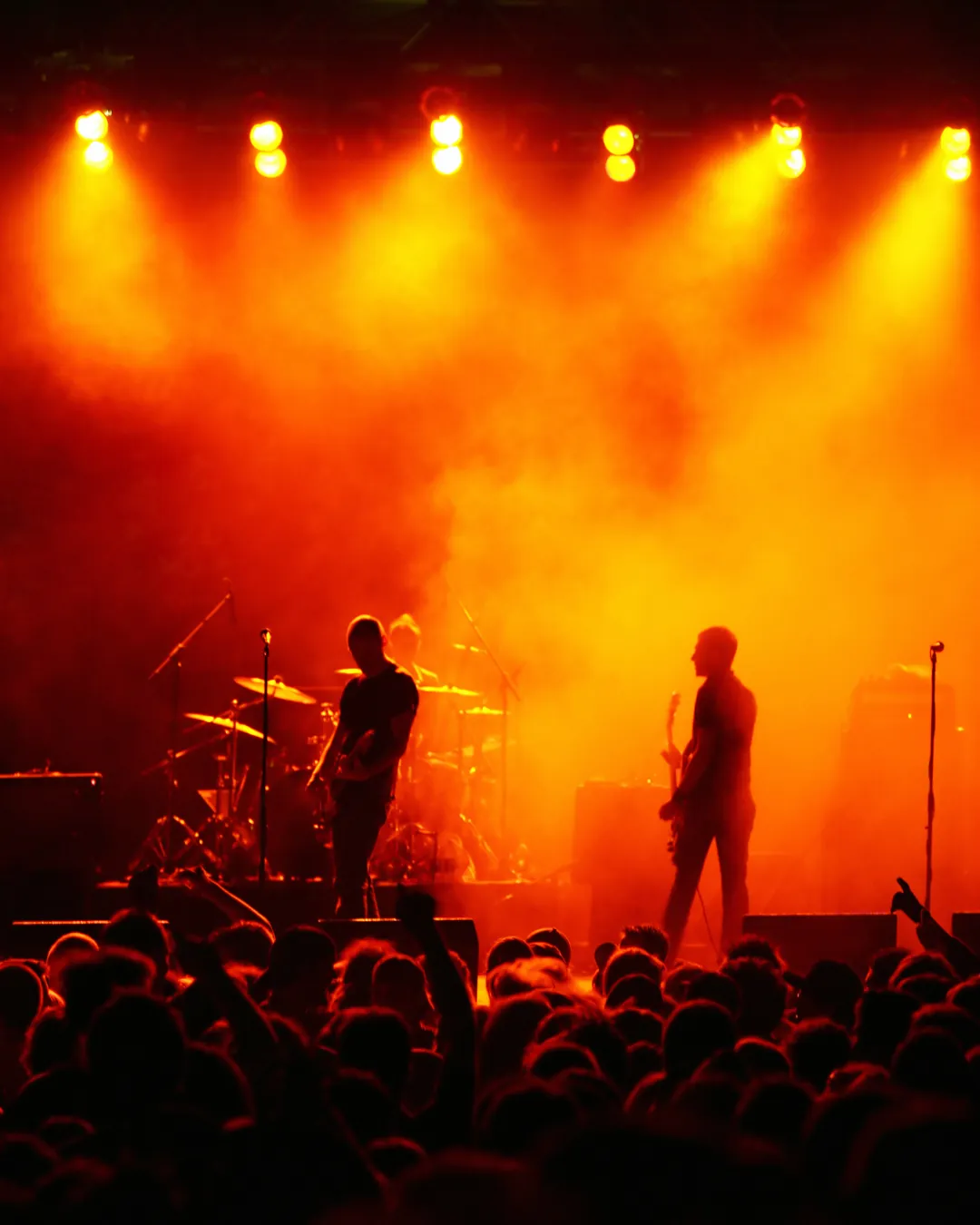 Los Premieres de LA performing under ember-colored stage lights